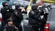 Police surround an apartment building in Watertown, Mass.