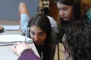 Yael Sternberg, left, and Hannah Skoff, eighth-graders at the Solomon Schechter Day School of Greater Boston, working on a science experiment with their teacher. (Courtesy Solomon Schechter Day School of Greater Boston)